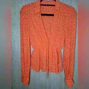 Free people orange and white long sleeve blouse with buttons and tie.